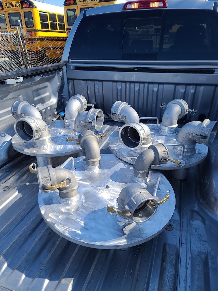 Custom aluminum manifold assemblies with cam-lock fittings ready for delivery to a shipyard