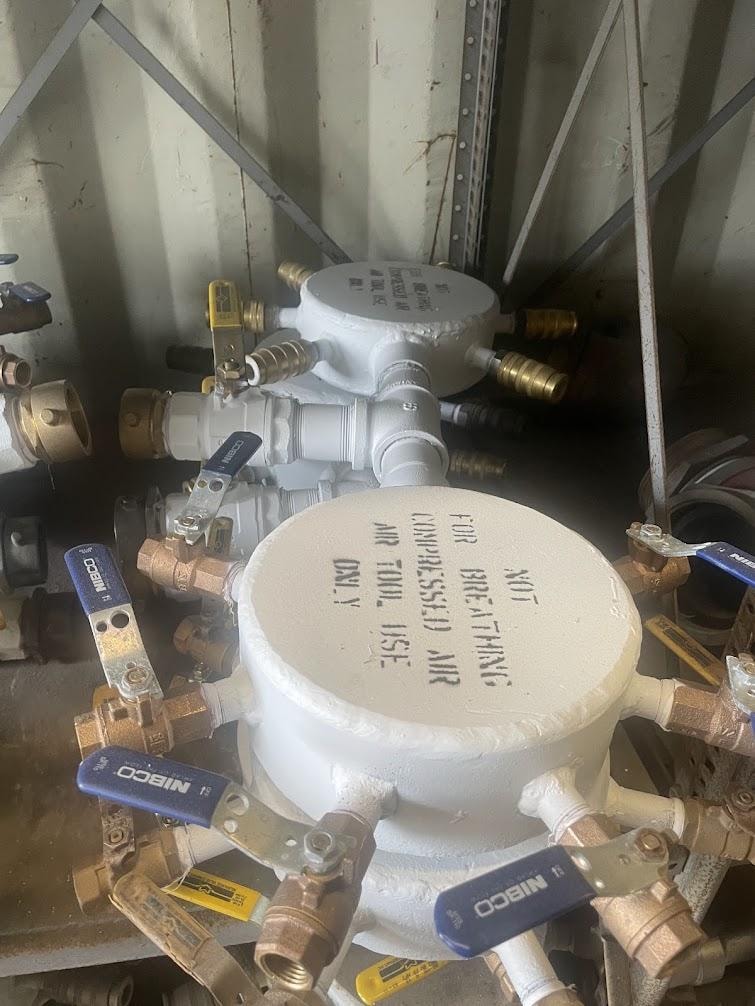 Shipboard compressed air manifold with NIBCO ball valves — labeled for air tool use only