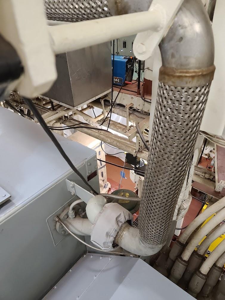 Stainless braided hydraulic hose fitting installed on a shipboard mechanical system